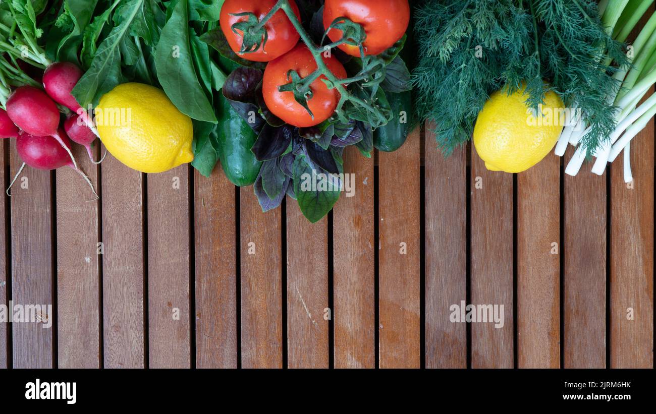 Vegetables and greens on a wooden background with space for text Stock ...