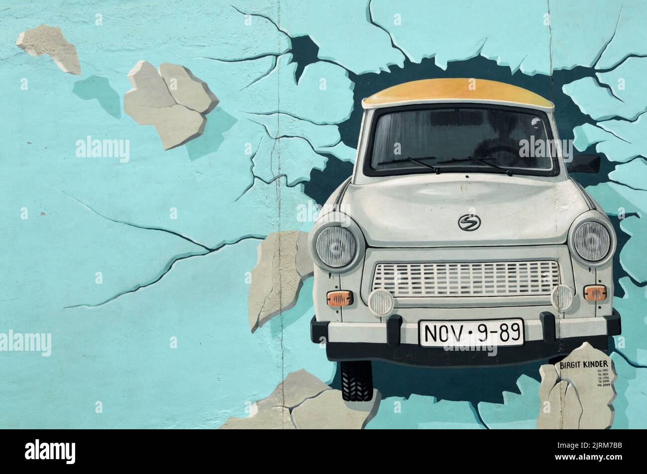 Grey Trabant car breaking trough the Berlin Wall from east to west Stock Photo