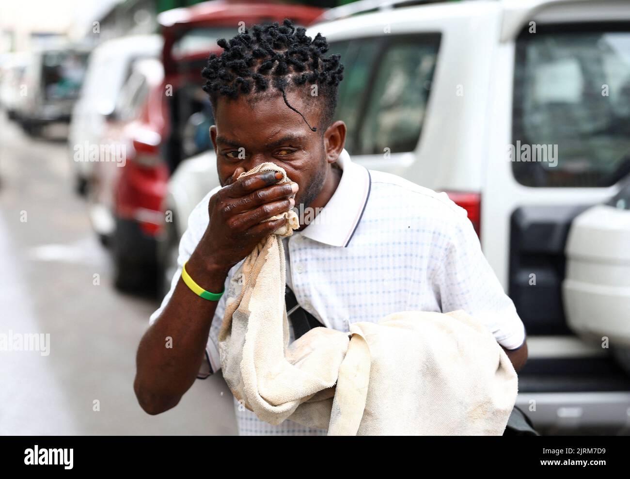 A man reacts after police officers fired teargas, as Angola's election commission says ruling MPLA party leads with 52% majority, after the general election close in Luanda, Angola August 25, 2022. REUTERS/Siphiwe Sibeko Stock Photo