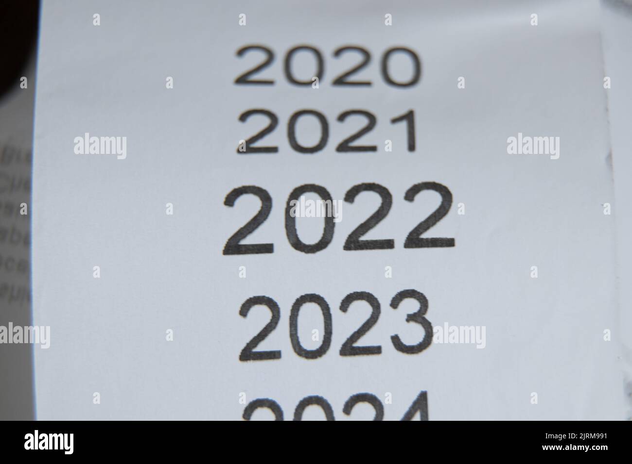 years in the checklist 2020,2021,2022,2023 as a list of years printed on checks, new year 2022 on paper as a background, a list with a list of years Stock Photo