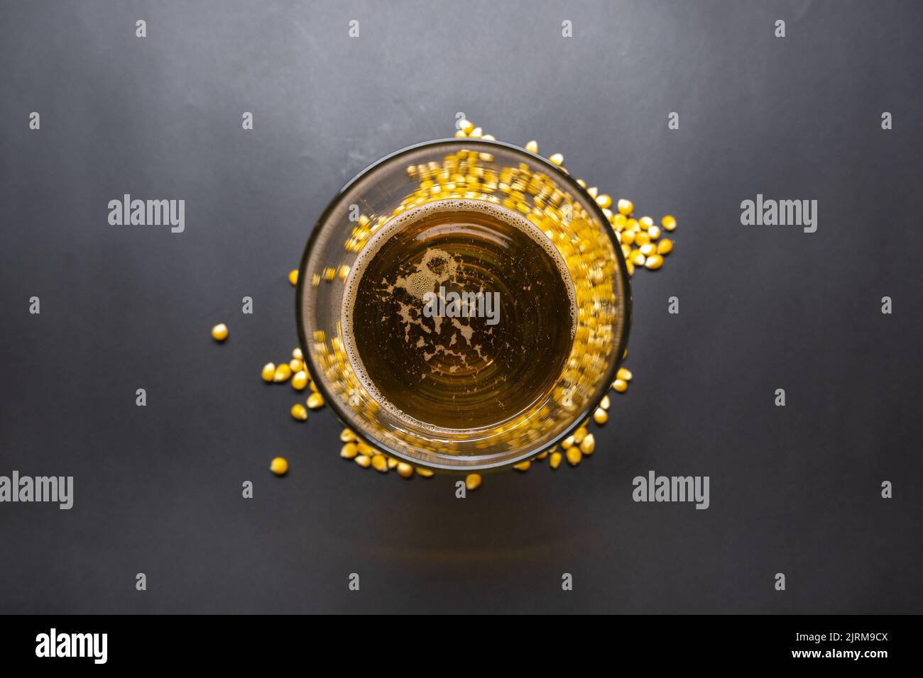 Beer glass on  raw corn, beer glass of corn on black background, beer concept idea photo, isolated photo, top view photo. Stock Photo