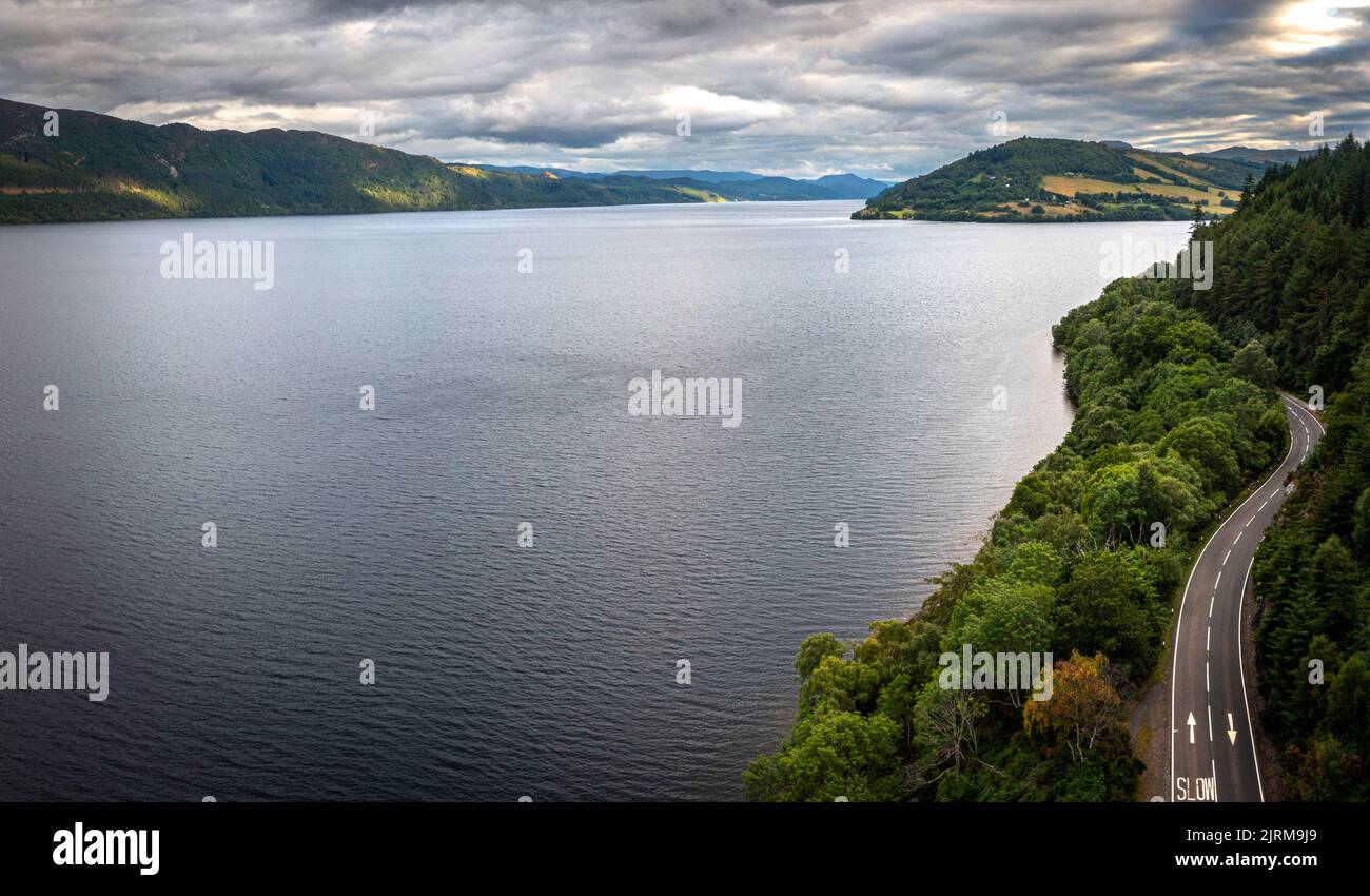 The A82 as it snakes around the headland and into Urquhart Bay and Drumnadrochit on the northern side of Loch Ness. Stock Photo