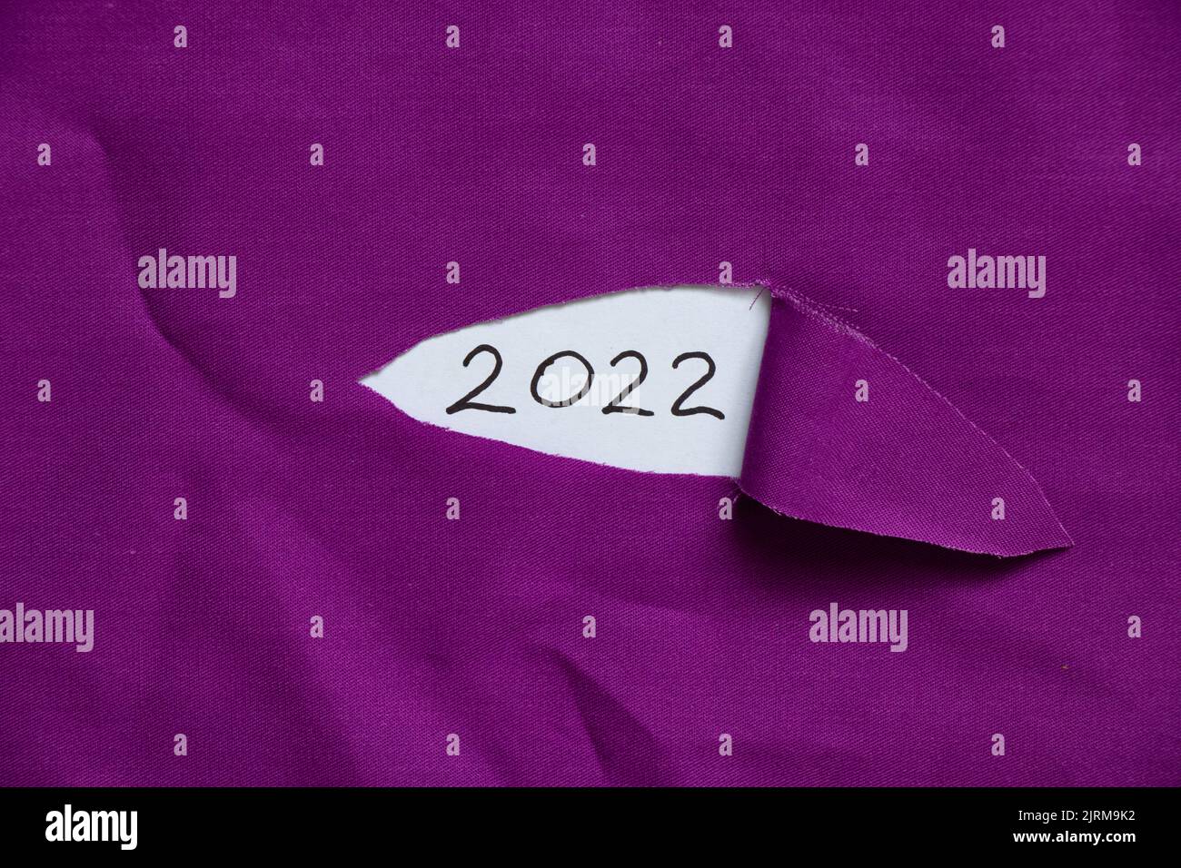 2022 written on paper on torn fabric, happy new year 2022, text Stock Photo