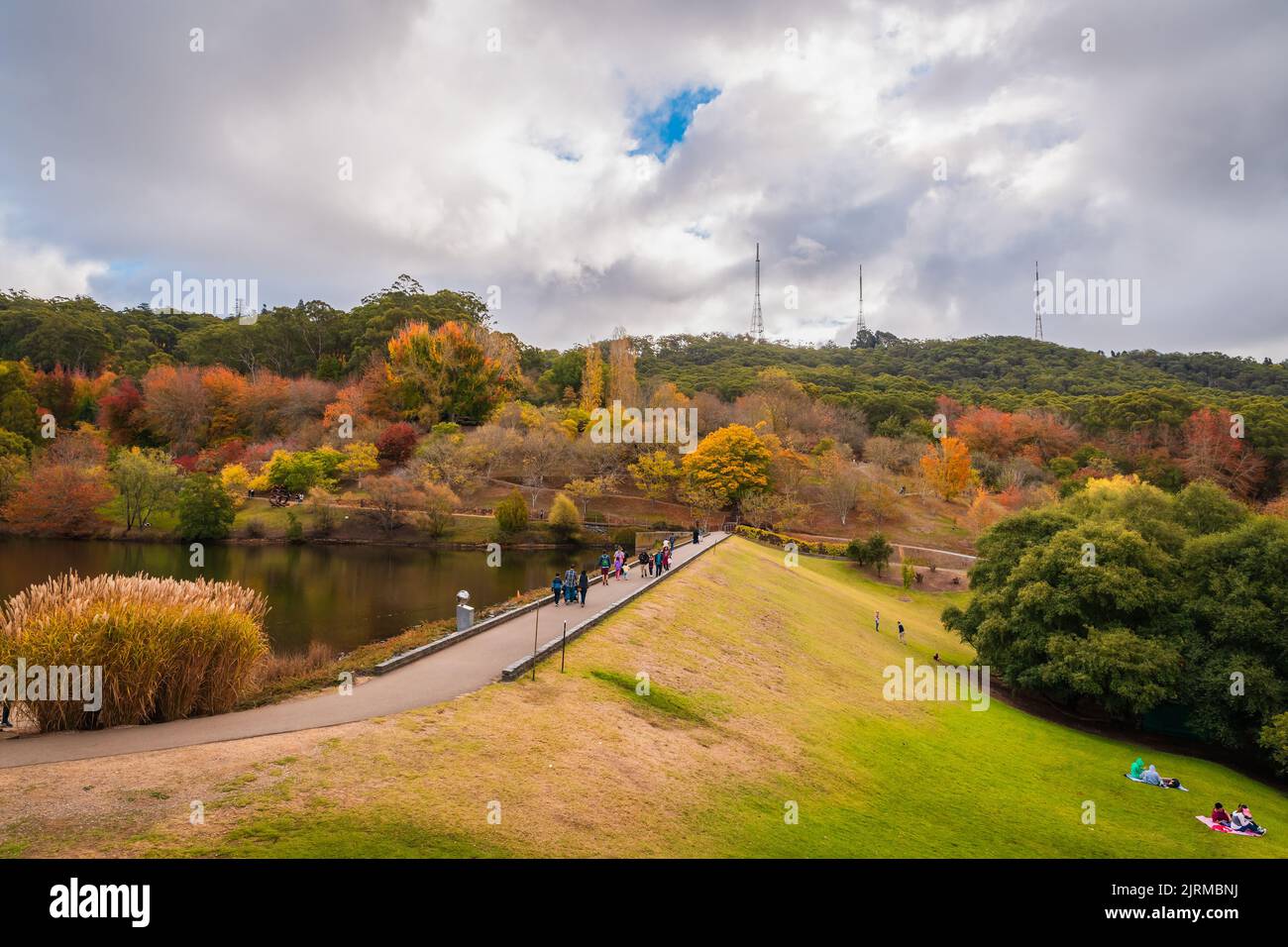 Crafers, South Australia - May 1, 2022: Mount Lofty Botanic Garden with people walking along the pond on a day during autumn season Stock Photo