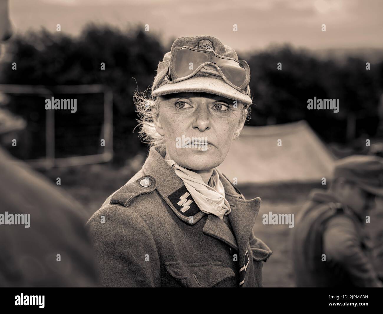 A closeup of a woman reenactor soldier in a military uniform during WW2. Historical reenactment Stock Photo