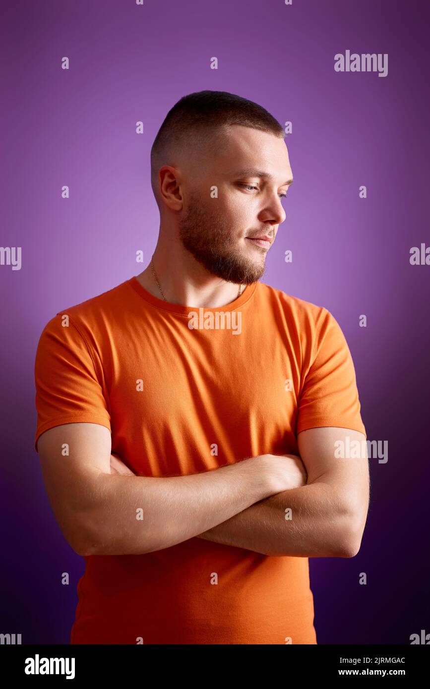 smiling young guy posing with crossed arms Stock Photo