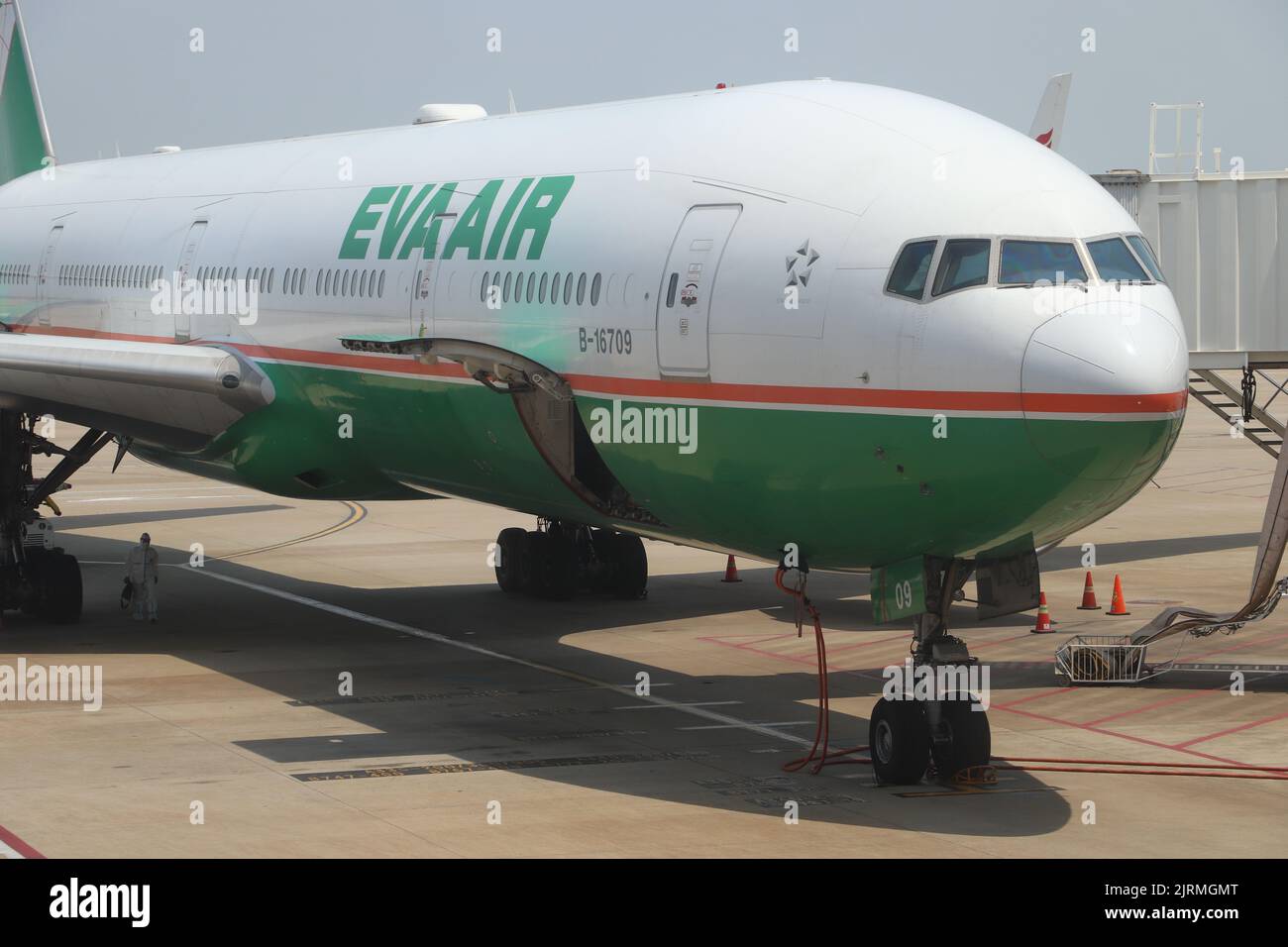 The white, green and red EVA Air Boeing B777-300ER at Shanghai Pudong Airport Stock Photo