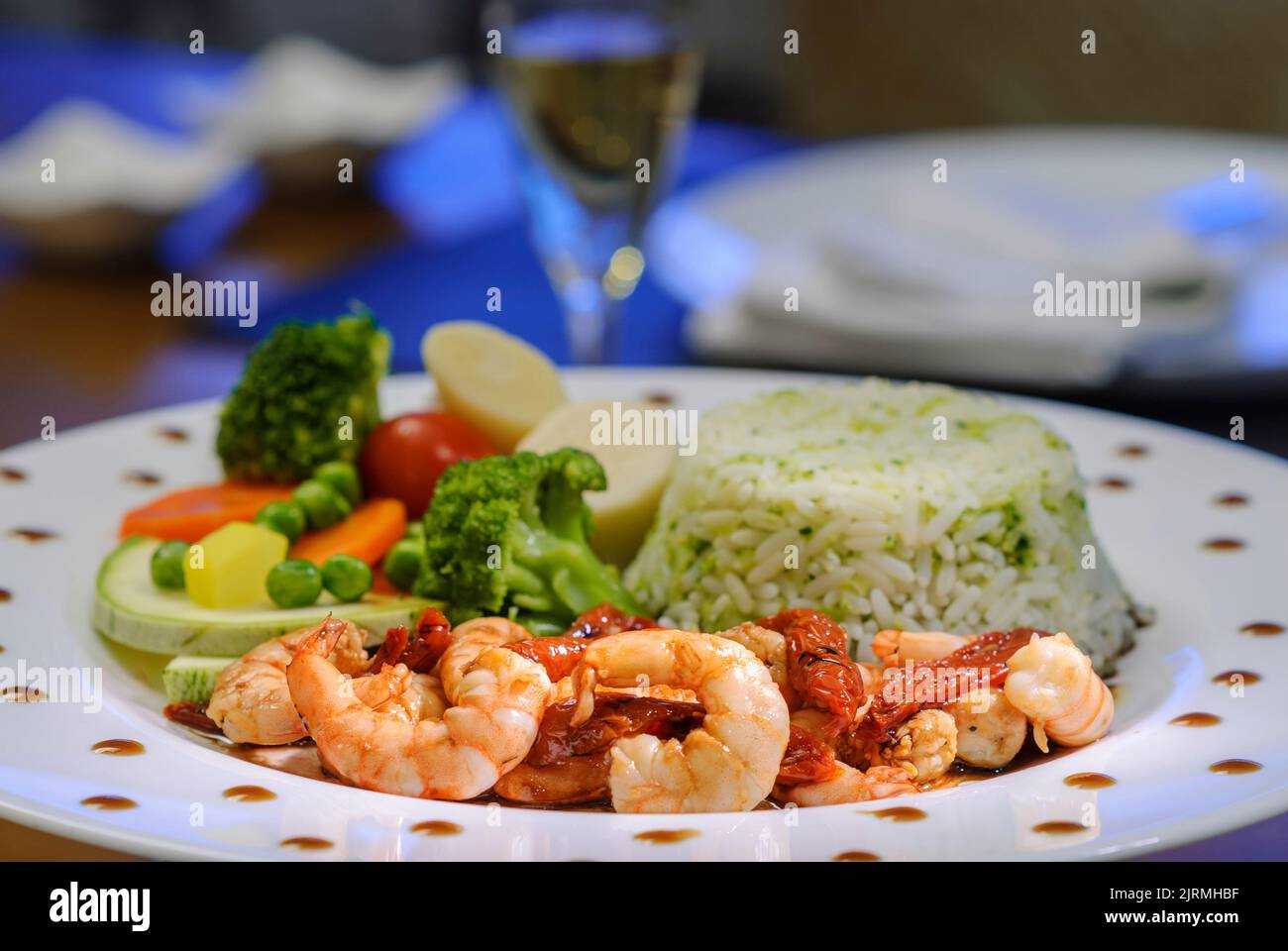 Shrimps with sundried tomatoes, rice and vegetables. Brazilian seafood