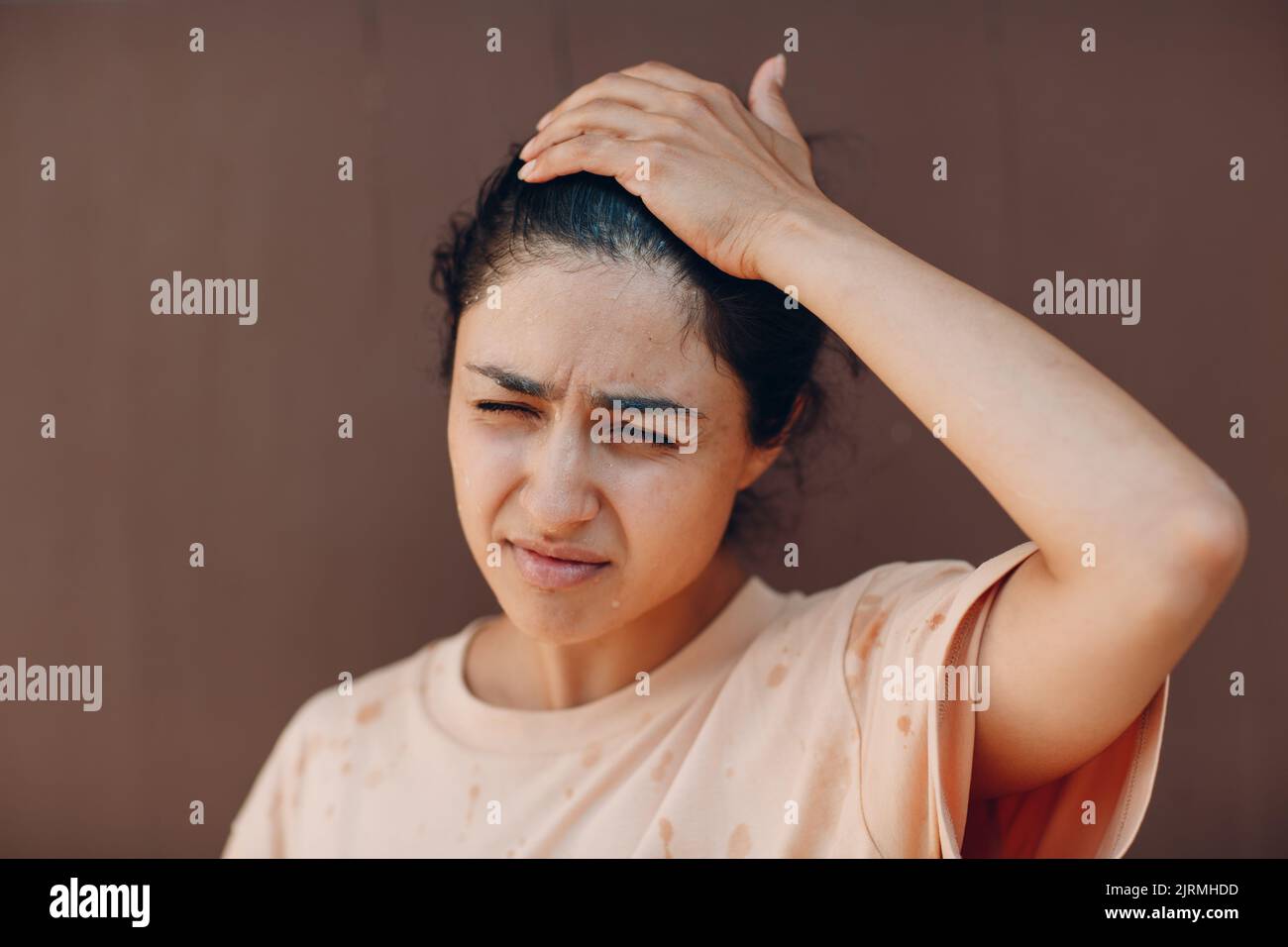 Stressed woman suffering of heatstroke refreshing with cold water