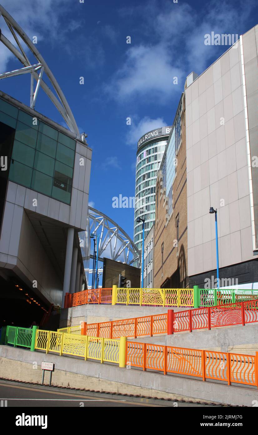 Multicolored railings on pedestrian walkway from area outside Moor Street station up ramp towards New Street in Birmingham city centre. Stock Photo