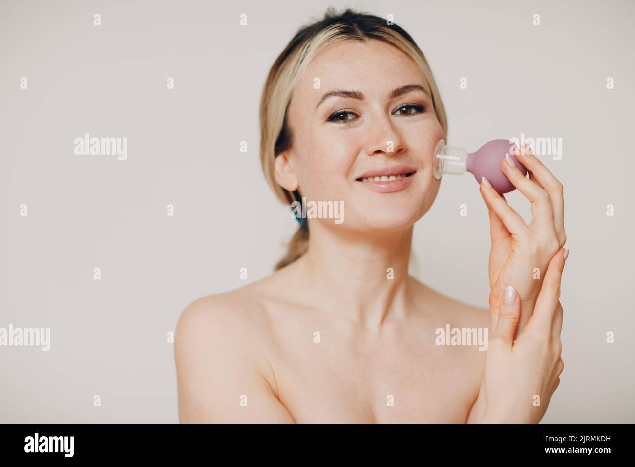 Cupping therapy procedure, woman with little medical cup for face Stock