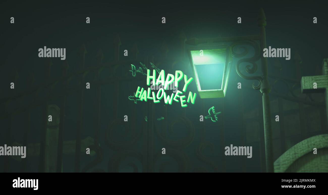 Digital composite image of illuminated lamp post by closed gate at night, happy halloween text Stock Photo