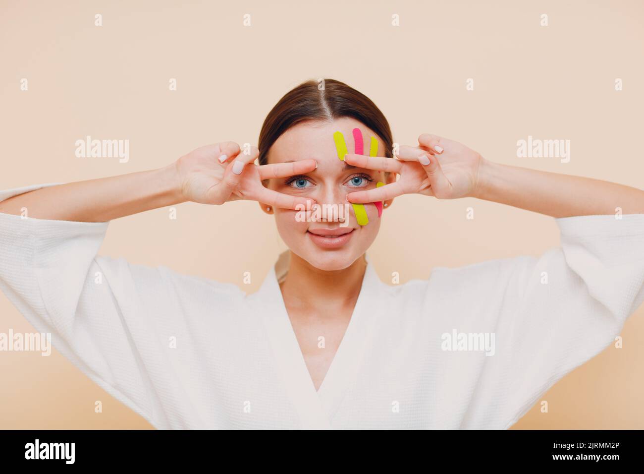 Beautiful woman applying tape lifting treatment procedure on face Stock Photo Alamy