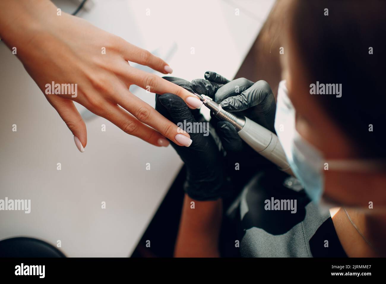 Manicure process female hands finger nails polish. Fingernail polishing