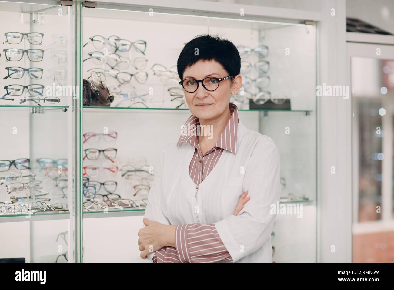 Portrait of an optometrist ophthalmologist middle aged adult woman wearing protective medical face mask. Stock Photo