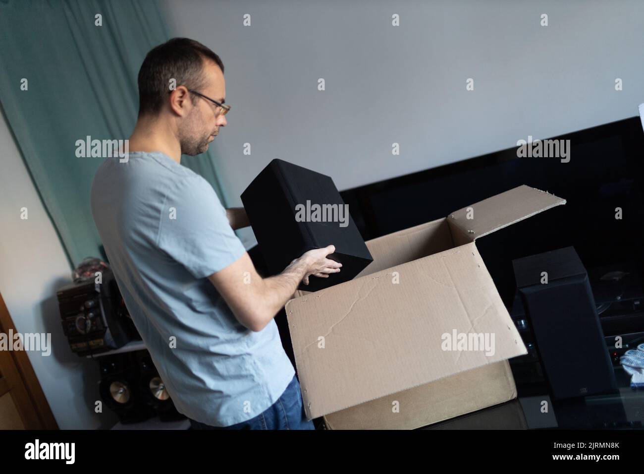 Adult man small business owner packing order box package shipping to