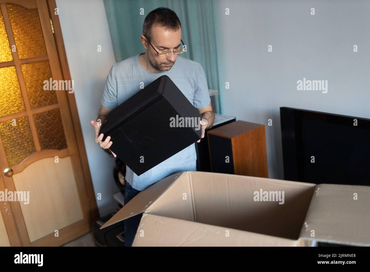 Adult man small business owner packing order box package shipping to ...
