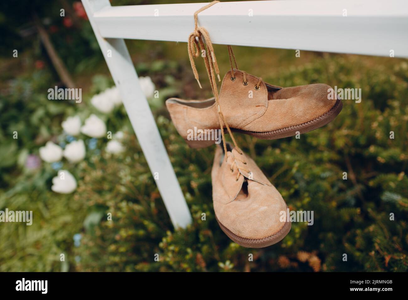 old brown suede boots hanging on laces Stock Photo - Alamy