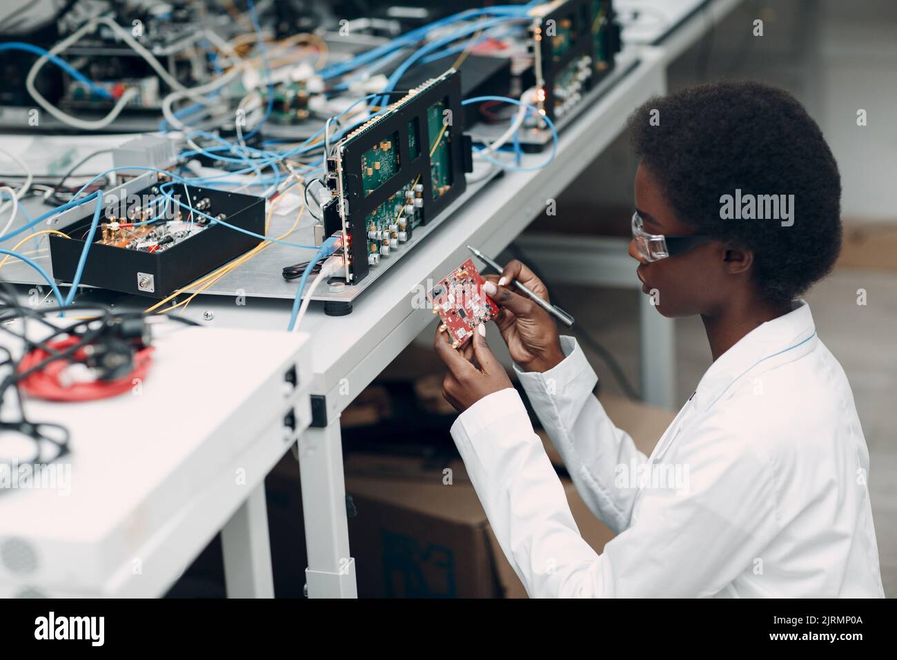 Scientist african american woman working in lab and single photon ...