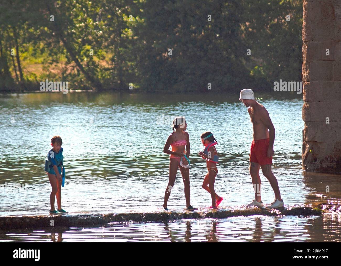 Children enjoying the waters of the River Orb, by Roquebrun in southern France Stock Photo