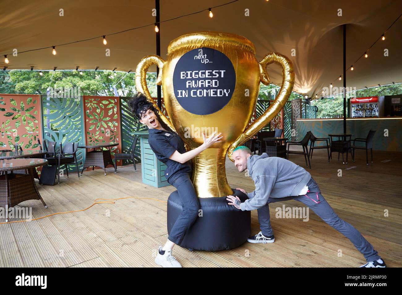 Edinburgh, UK. 25th Aug, 2022. Jordan Gray (L) wins NextUp's ‘Biggest Award in Comedy' at the Edinburgh Festival Fringe for her show 'Is it a Bird'. A giant two metre inflateable trophy was Awarded to Jordan by Dan Berg from NextUp. Credit: Brian Wilson/Alamy Live News Stock Photo