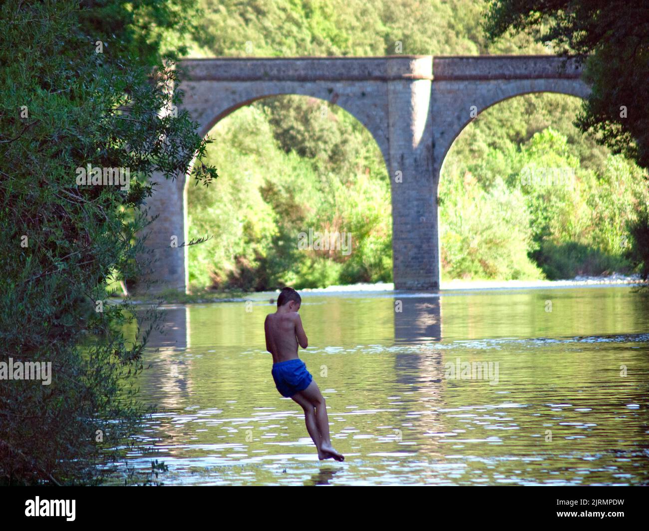 Jumping into the River Orb near the village of Roquebrun in southern France Stock Photo