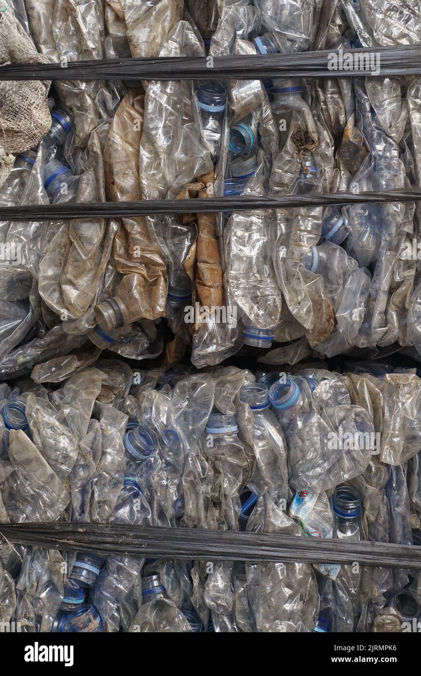 A vertical shot of a pack of mineral water bottles ready to recycle