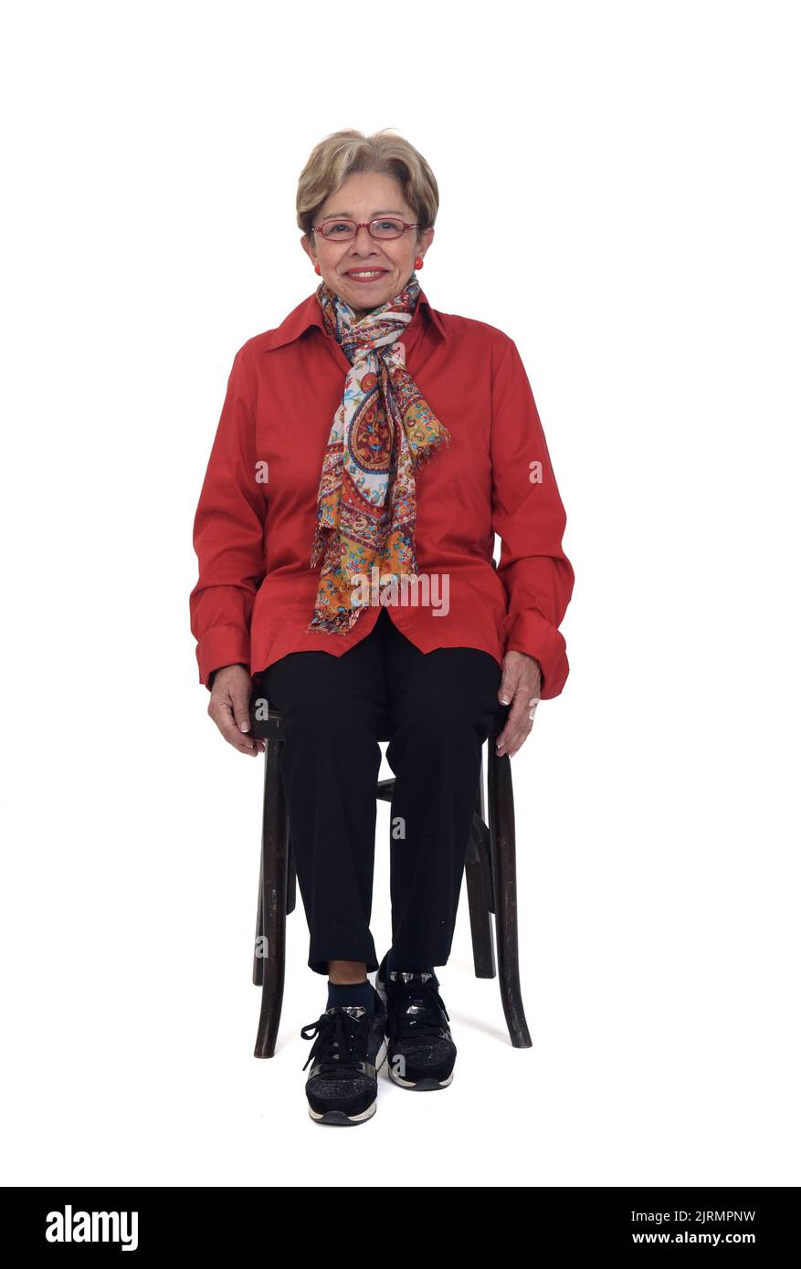 senior woman sitting on chair on white background Stock Photo - Alamy