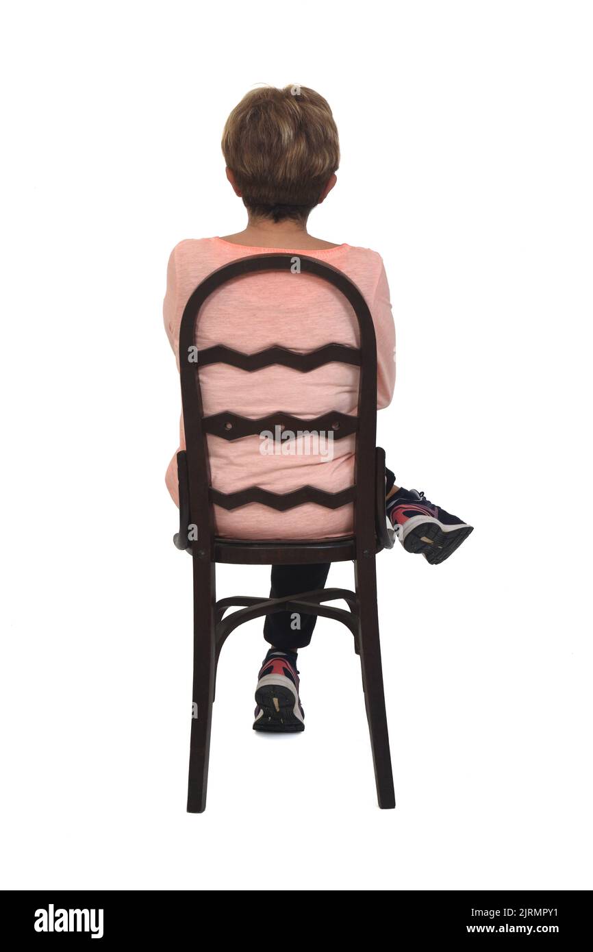 back view of senior woman sitting on chair legs and arms crossed white ...