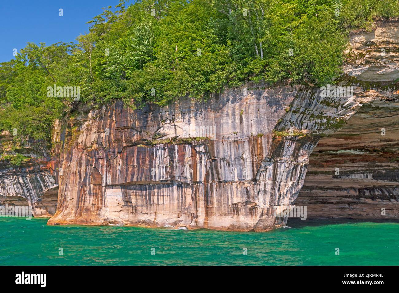 Colorful Seeps in Lakeshore Sandstone on Lake Superior in Pictured Rocks National Lakeshore in Michigan Stock Photo