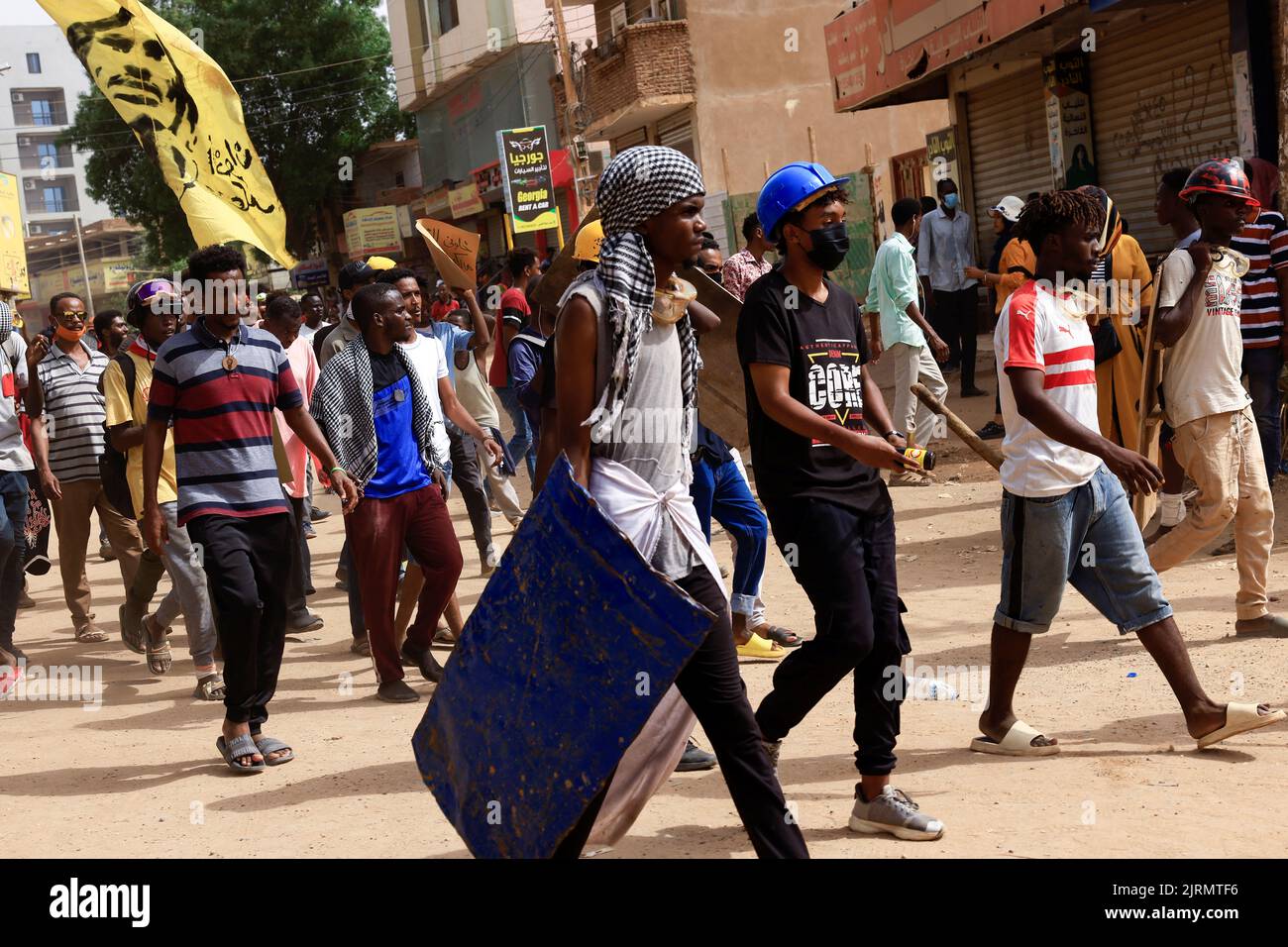 Demonstrators, some holding makeshift shields, march during at a rally against military rule following the last coup, in Khartoum, Sudan August 25, 2022. REUTERS/Mohamed Nureldin Abdallah Stock Photo