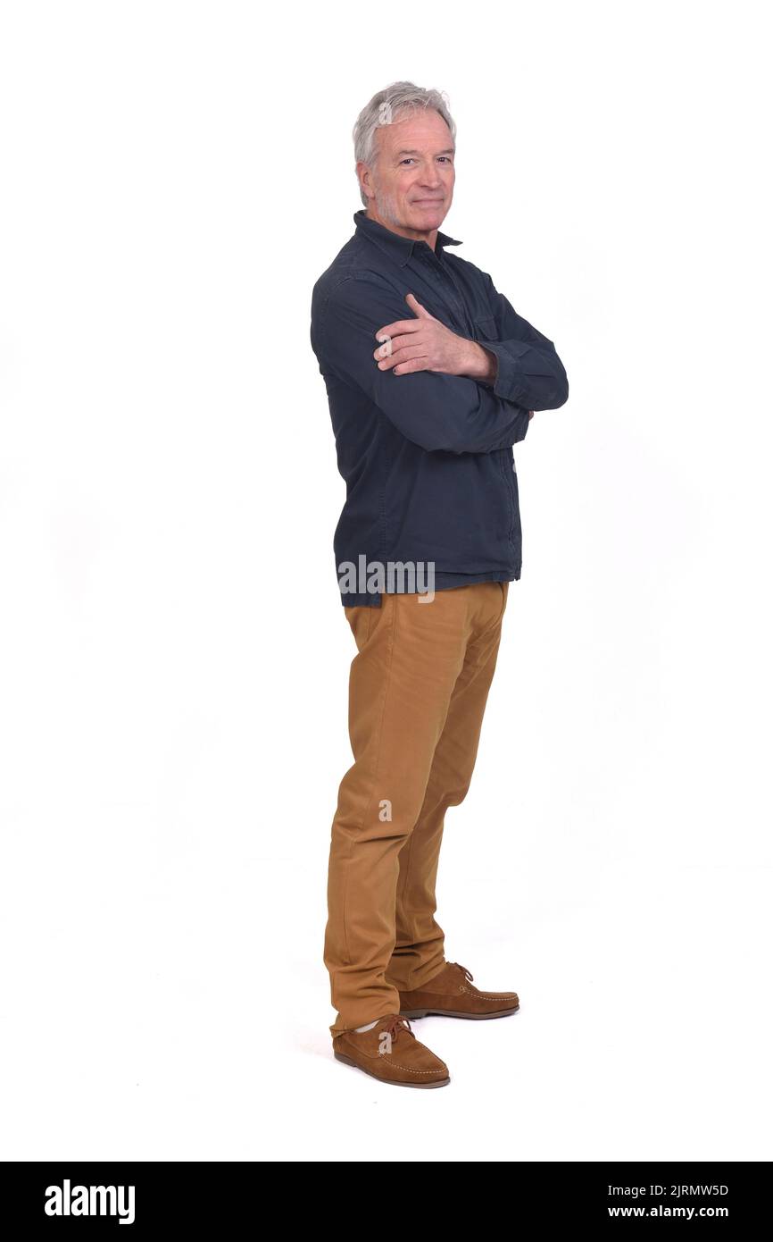 side view of a man looking at camera and arms crossed on white ...