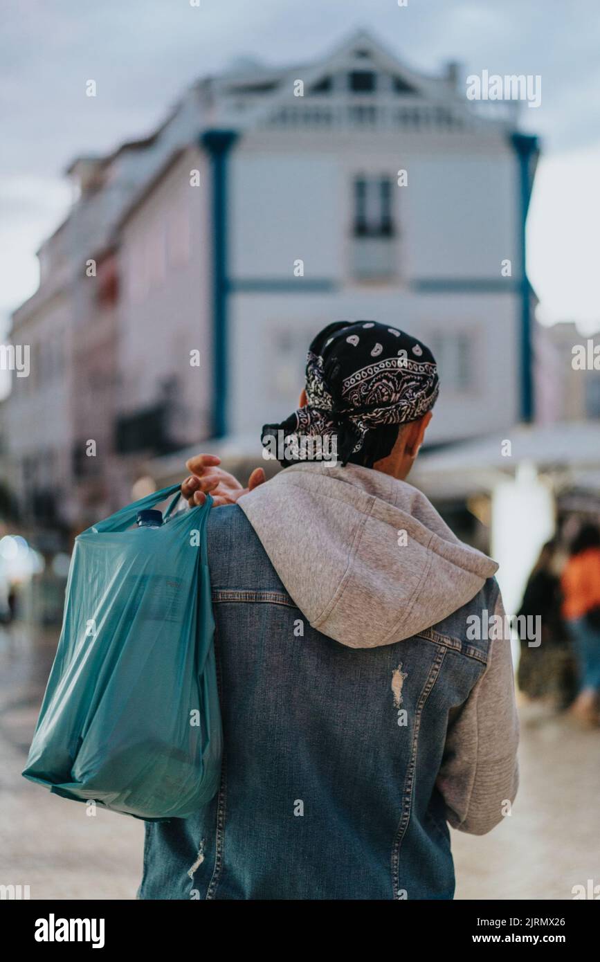 A back view of a male carrying a bag in Lagos, Portugal Stock Photo Alamy