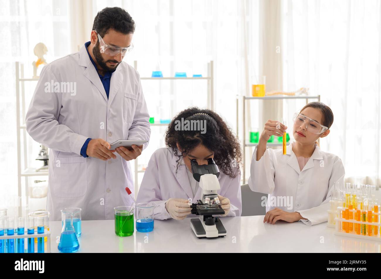 Modern laboratory scientists team conduct experiments Stock Photo