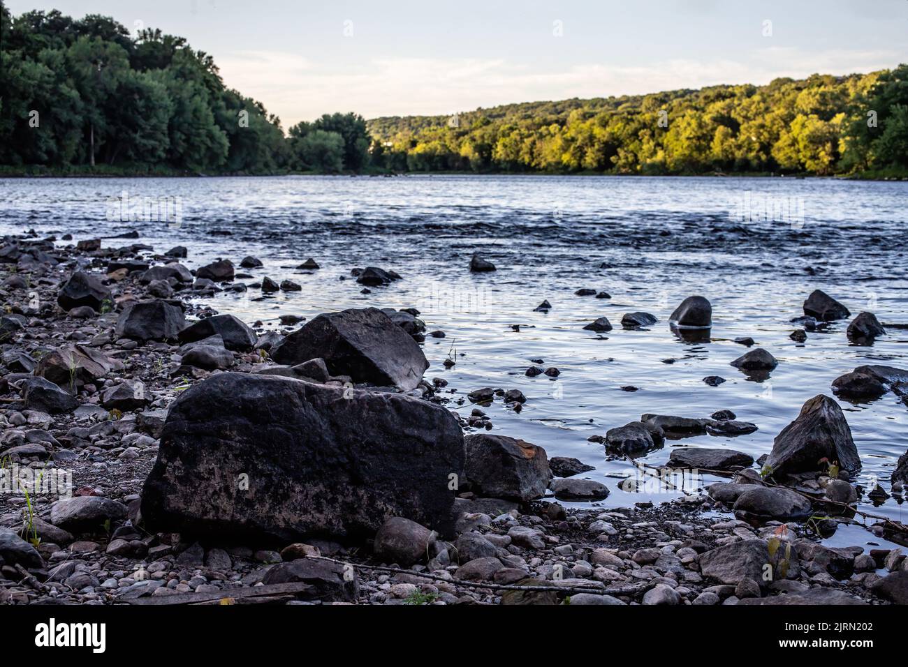 St. Croix River's rocky shoreline in the evening at Taylors Falls ...