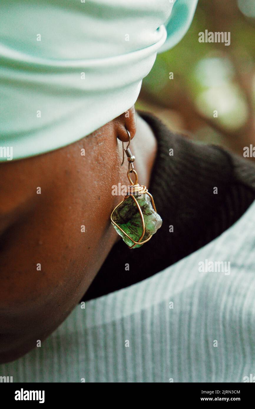 A vertical shot of a Nigerian woman with a green earring Stock Photo