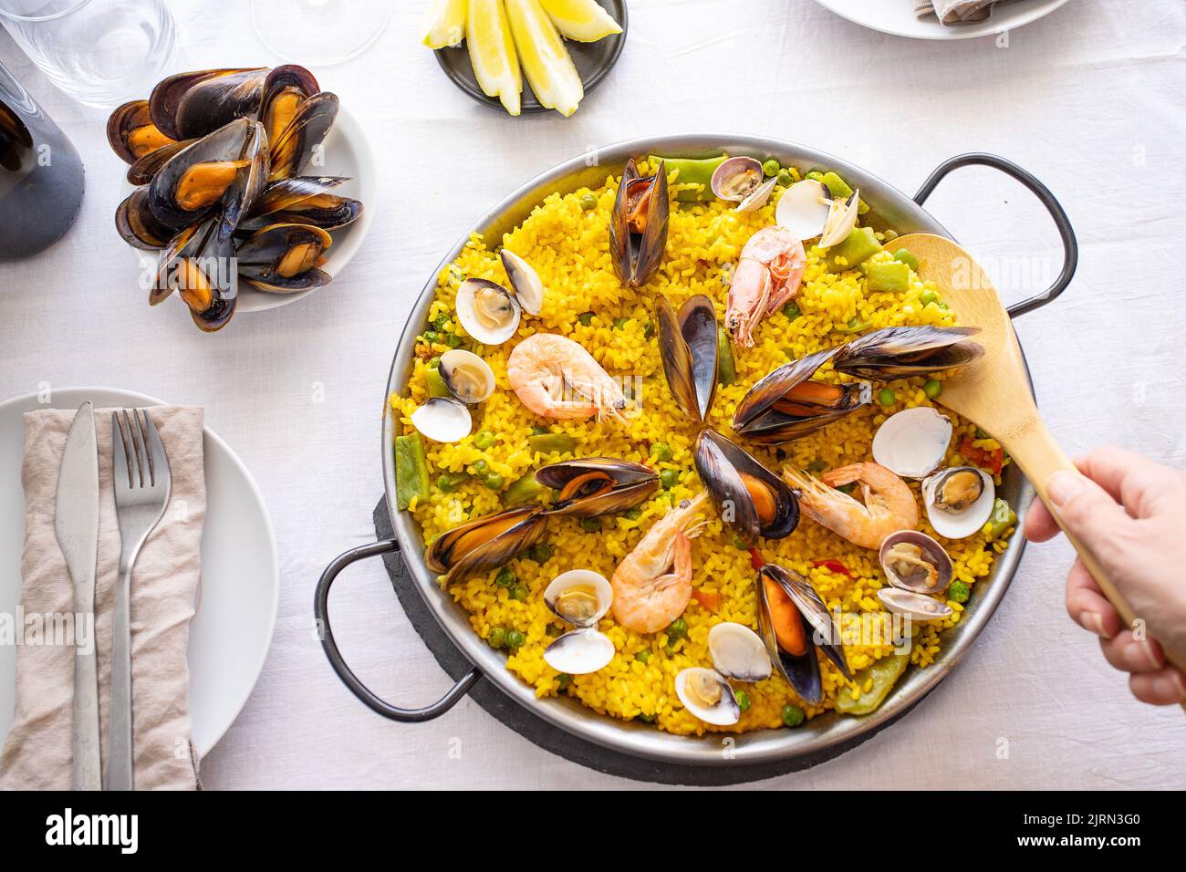 Top view of Seafood Paella with prawns, clams, mussels on saffron rice