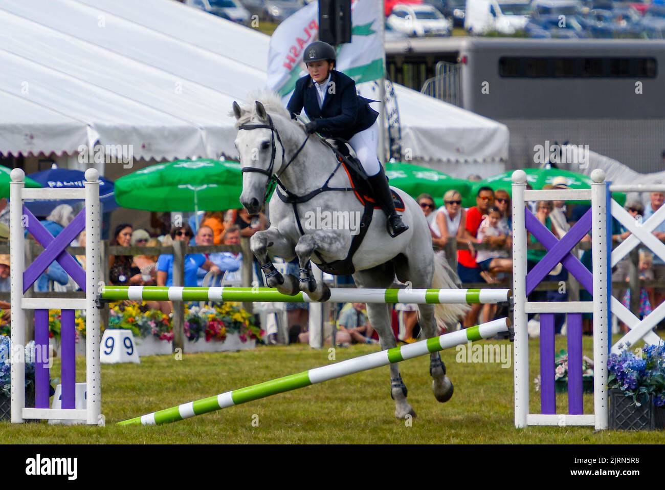 Bridport, Dorset, UK.  25th August 2022.  Showjumping at the Melplash Show at Bridport in Dorset which returns after a gap of three years due to the Covid-19 pandemic.  Picture Credit: Graham Hunt/Alamy Live News Stock Photo