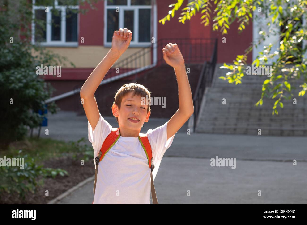 A happy smiling child goes to school. Happy boy with a backpack and a ...