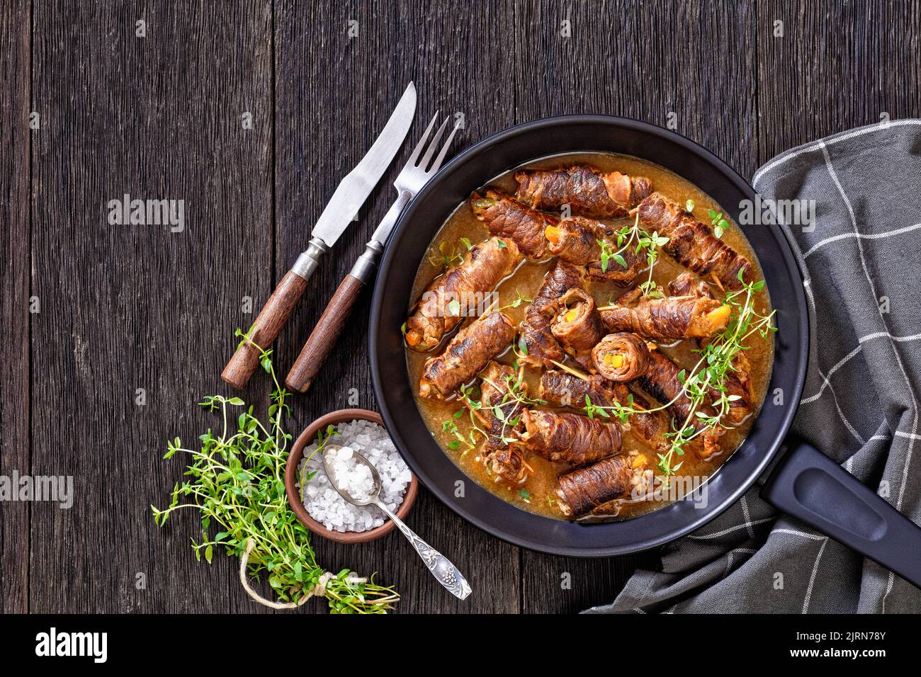 beef rouladen stuffed up with mustard, pickles, carrot and onions in