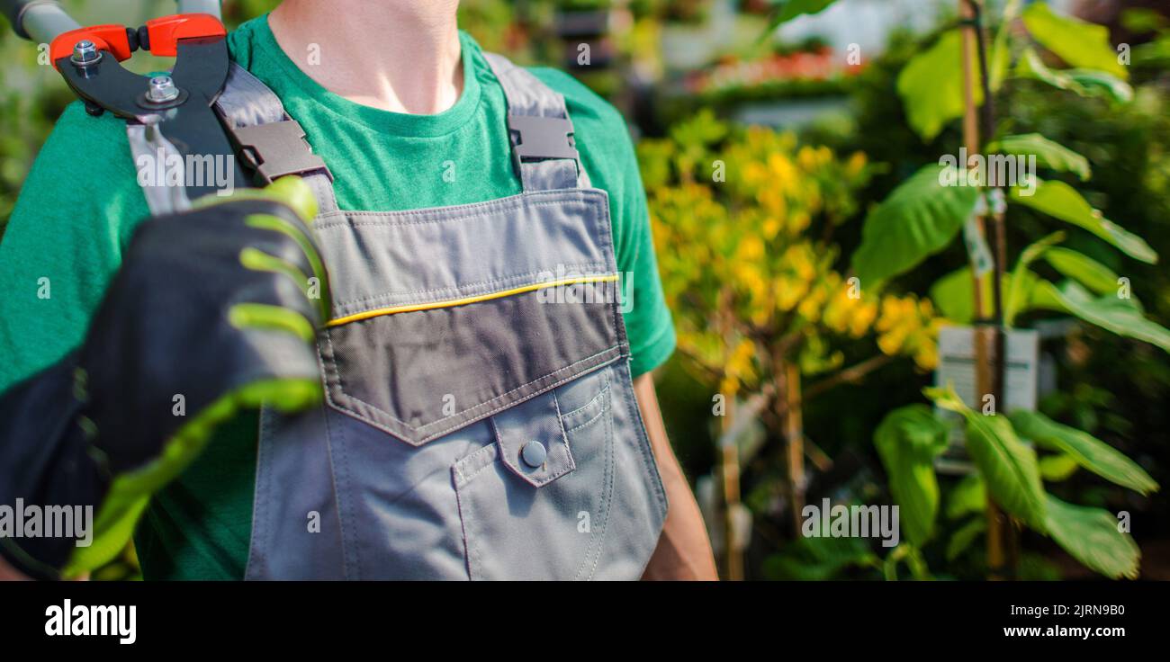 Professional Caucasian Gardener with Large Garden Scissors on His