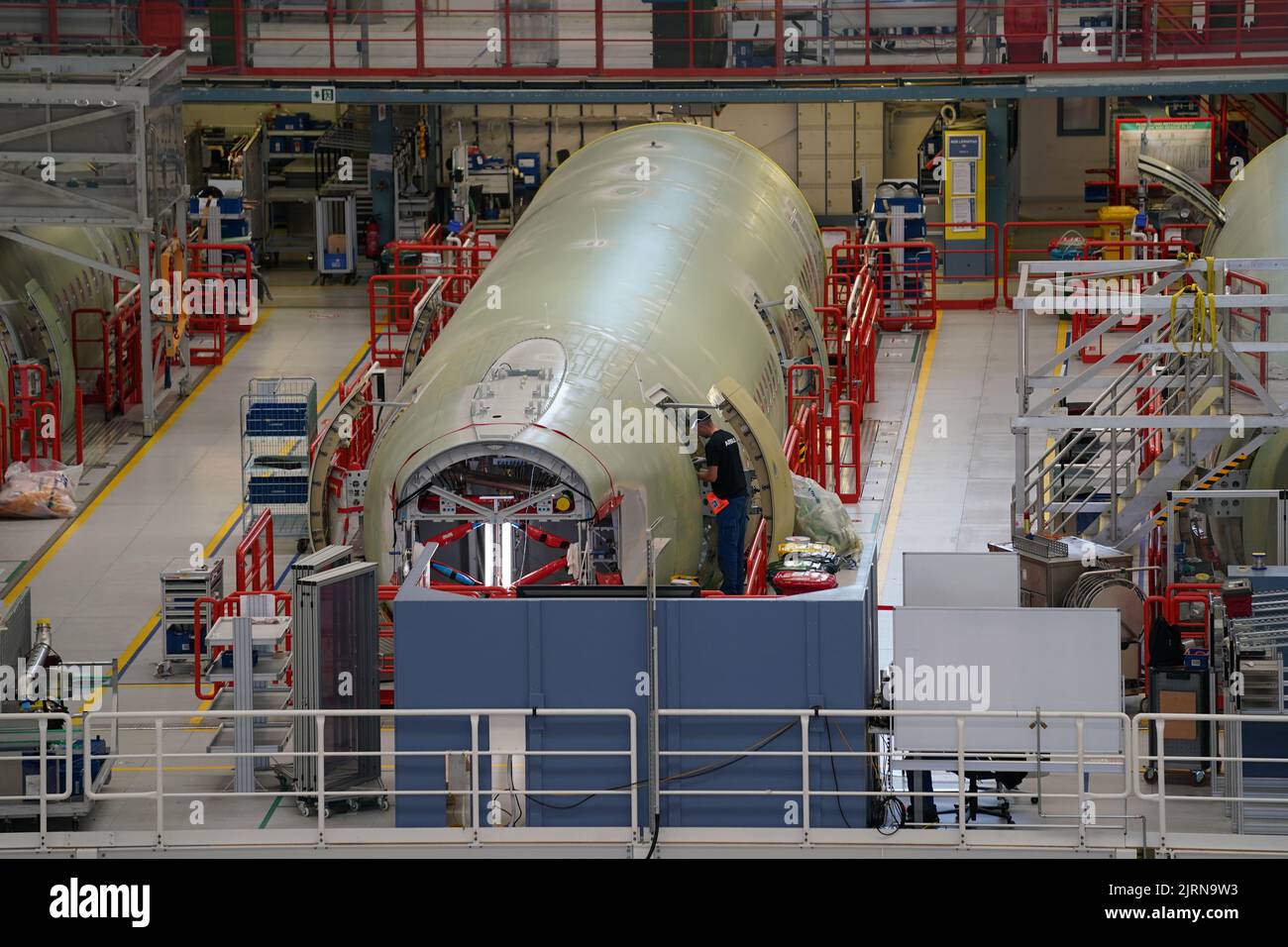 24 August 2022, Hamburg: Airbus employees work on the A320 fuselages in ...