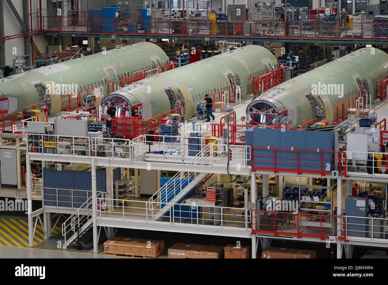 24 August 2022, Hamburg: Airbus employees work on the A320 fuselages in ...