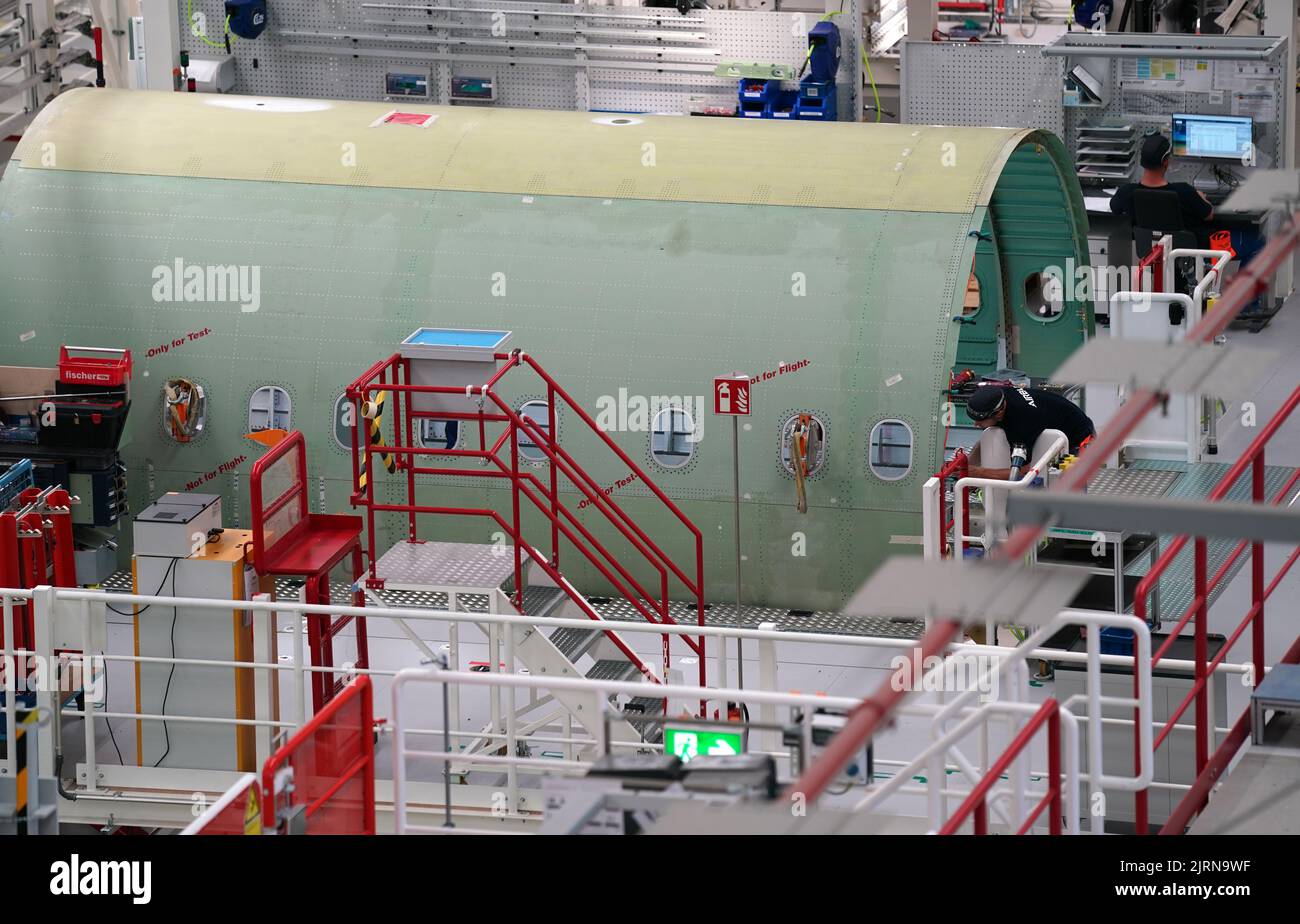 24 August 2022, Hamburg: Airbus employees work on the A320 fuselages in ...