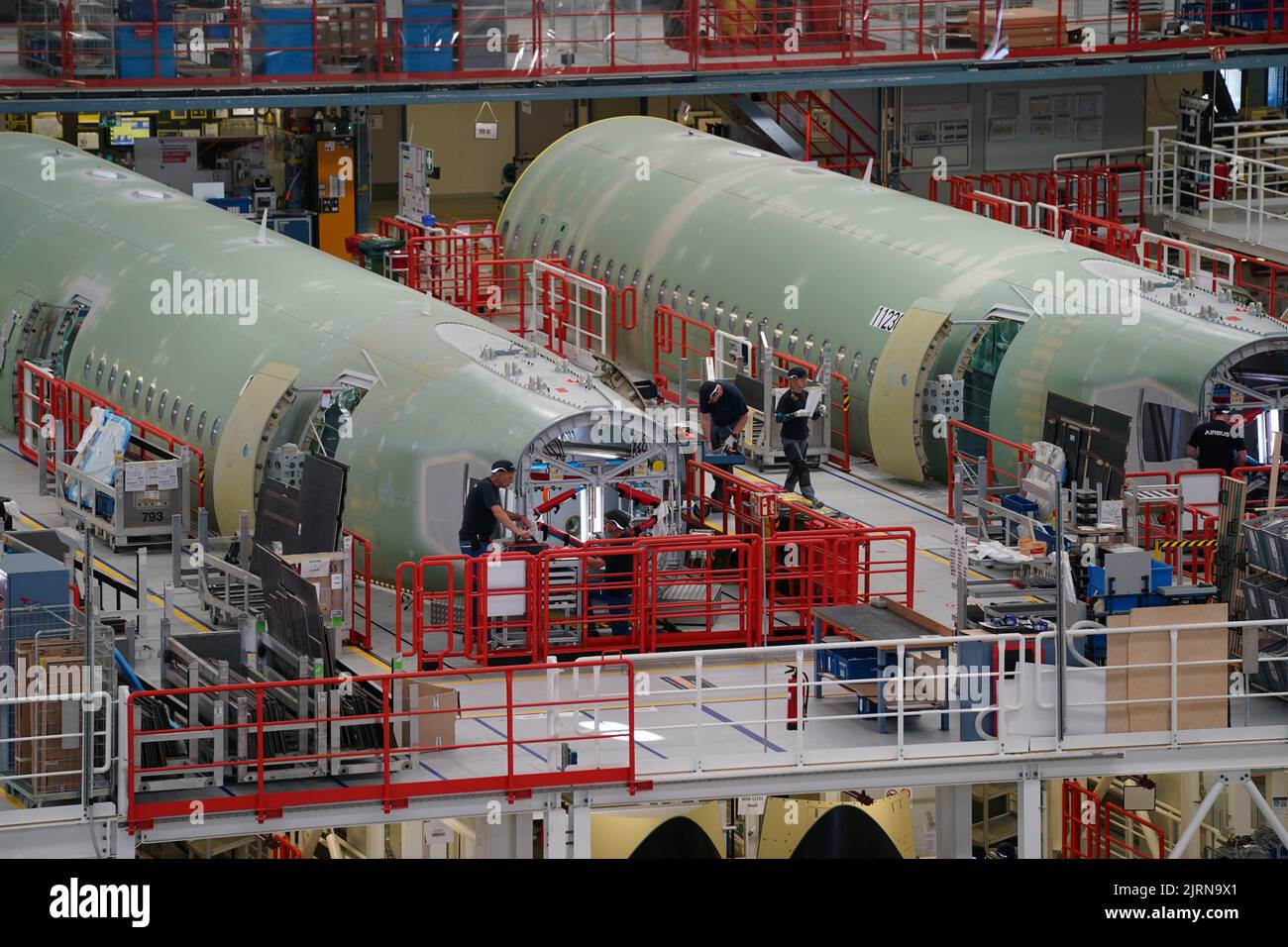 24 August 2022, Hamburg: Airbus employees work on the A320 fuselages in ...