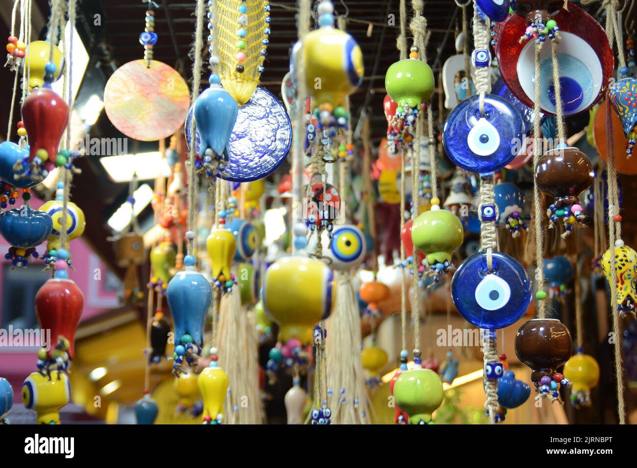 Multi-colored wall and ceiling retro  ornaments, various ceramics and threads and trinkets hung on the wall Stock Photo