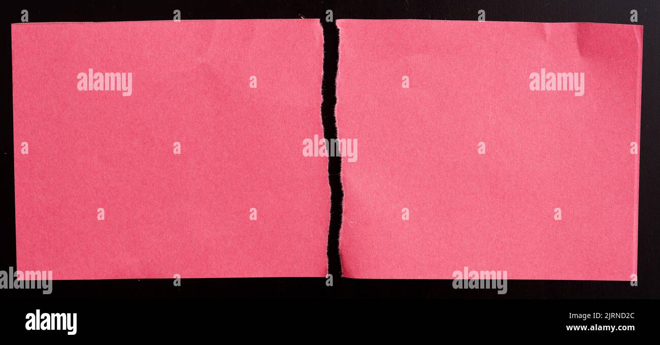 Red torn paper on black background Stock Photo
