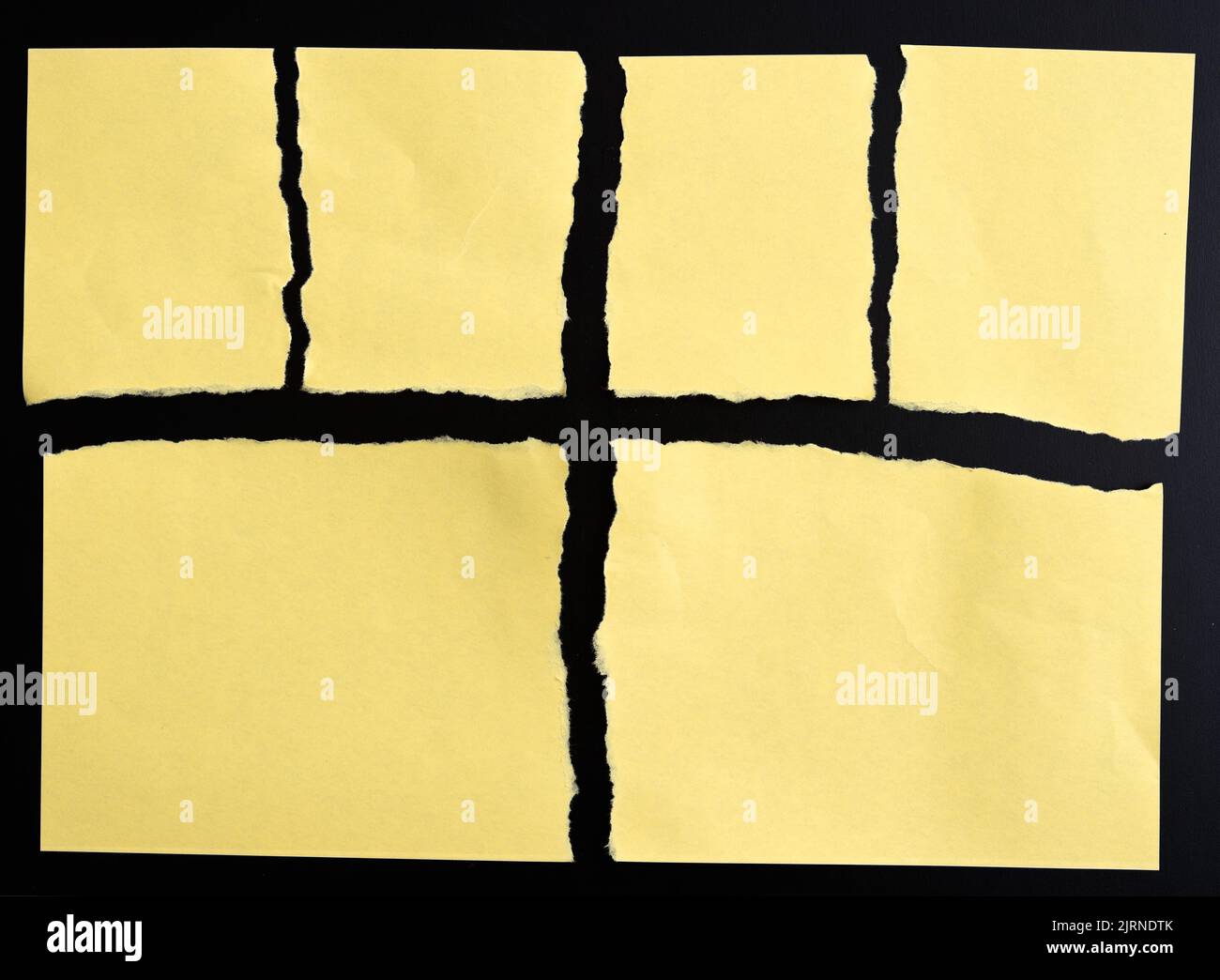 Torn yellow paper on black background Stock Photo
