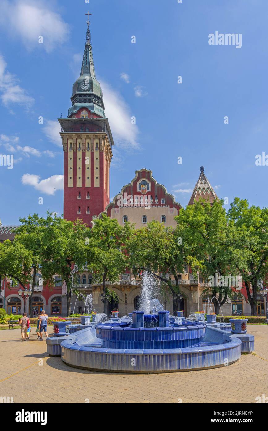 Subotica, Serbia - August 01, 2022: Blue Tiles Fountain Landmark and Historic City Hall Building Hot Summer Day. Stock Photo
