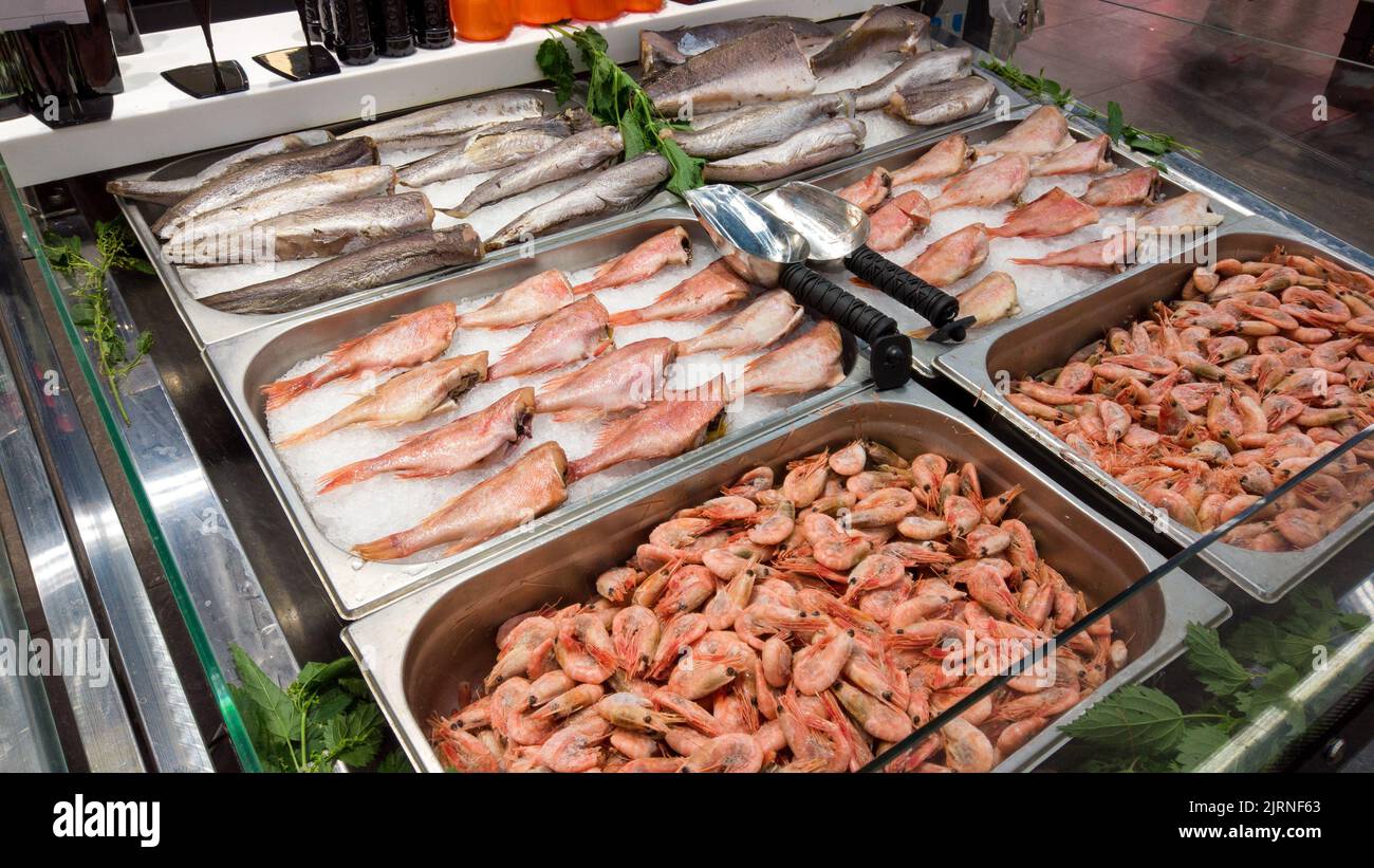 Seafood on ice at the fish market. Fresh raw fish selling in fridge